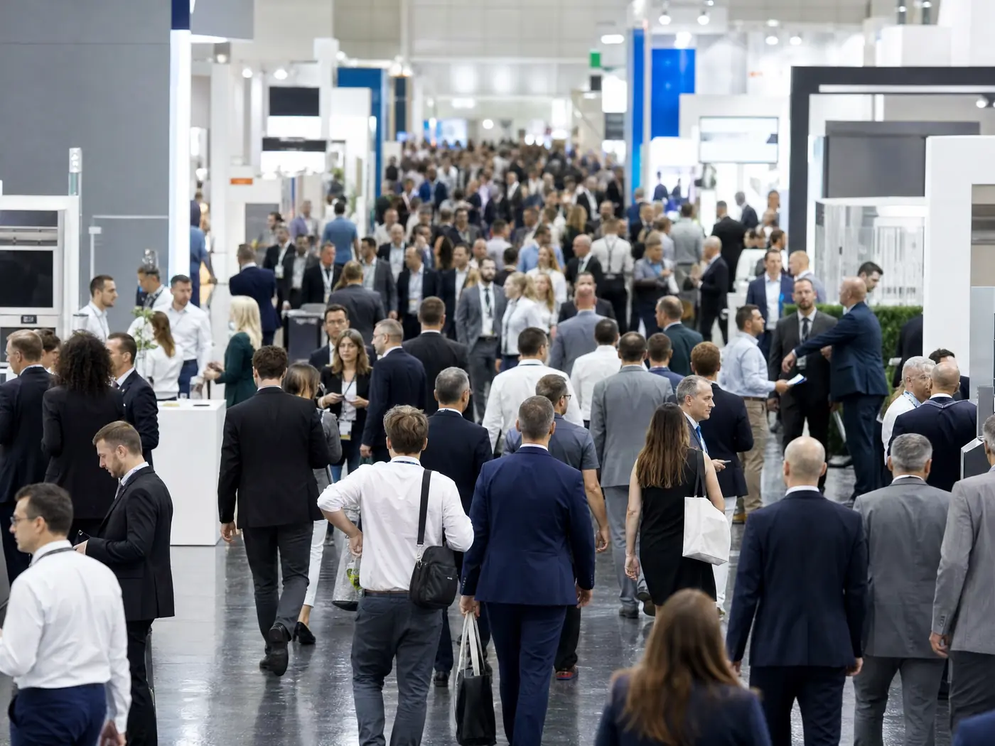 A packed trade show aisle at peak hour